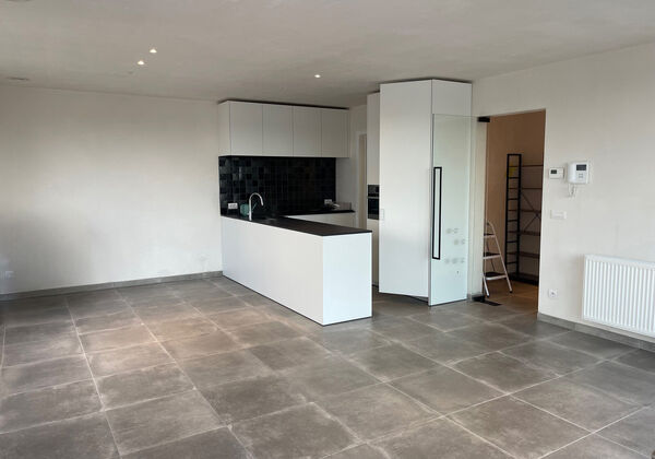 In een rustige buurt in Wetteren bevindt zich dit instapklare en lichtrijke appartement dat comfort en modern woonplezier combineert.

De ruime woonkamer met grote raampartijen zorgt voor een overvloed aan natuurlijk licht en geeft toegang tot een gezelli